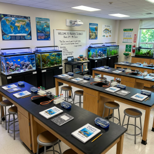 Classroom with aquariums, lab tables, notebooks, and science equipment for aquatic science lessons